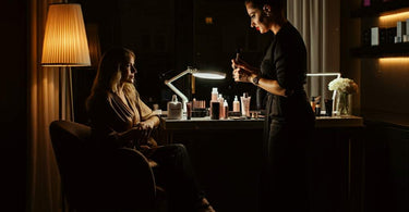 A spa professional preparing for an after-hours beauty service in a tranquil, softly lit setting