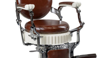 Albert Classic Barber Chair in rich brown upholstery by Hans Equipment, featuring a classic button-tufted design and hydraulic recline, displayed in a professional barbershop setting.