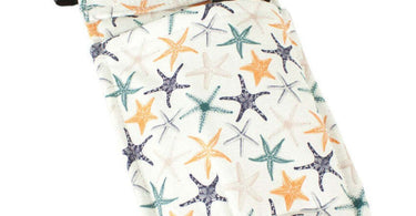 Starfish-shaped massage bottle holster attached to massage table with oil bottle securely in place