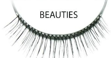 Close-up image of Ardell Invisiband Beauti Black false eyelashes on a clean surface, showcasing their natural, wispy design and invisible band.