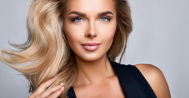 Attractive woman with teased hair using a teasing comb