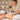 A relaxing spa treatment where an esthetician performs a back facial on a client, with organized product pairings nearby.