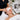 A professional esthetician applying a warm eye compress to a client before a facial extraction treatment to soften pores and improve results.