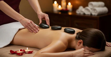Therapist performing hot stone massage with basalt stones