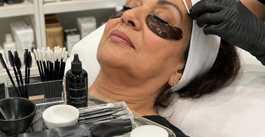 A professional applying a hydrating lash mask to a client after a tinting service to lock in color and moisture.