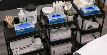 A professional salon setup featuring a box of disposable gloves at the service station, highlighting hygiene and readiness for beauty services.
