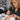 Nail dehydrator bottle and brush next to acrylic nail supplies on a salon table