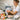 A professional aesthetician applying a bright yellow grapefruit oil infused body scrub to a client's arm, highlighting the benefits of using grapefruit oil in professional body scrubs for exfoliation and aromatherapy.