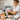 A professional aesthetician applying a bright yellow grapefruit oil infused body scrub to a client's arm, highlighting the benefits of using grapefruit oil in professional body scrubs for exfoliation and aromatherapy.