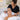 A professional applying mineral based foundation with a brush to a client after a relaxing facial treatment in a spa.