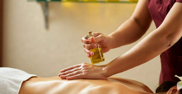 Assorted bottles of massage oils on a spa table