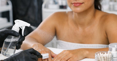 Best Methods For Cleaning Clogged Spray Tan Residue Near Nail Stations - Professional salon cleaning supplies and spray tan residue remover on a white manicure station.