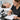 Lash artist documenting client lash tint formula changes in a file with a pen, surrounded by professional lash tint supplies from Pure Spa Direct.