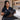 A professional stylist gently brushing long, silky synthetic hair extensions with a wooden brush in a bright, modern salon to neutralize static.