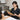 Professional bamboo massage sticks arranged on a heated towel for thermal spa therapy protocols.
