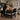 A therapist working on a client during a Lomi Lomi massage, with the massage table at the optimal height for body mechanics