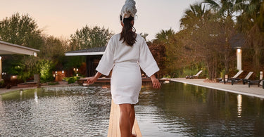 Blissful spa client walking on a balance beam, representing the harmony and equilibrium achieved through the ESS Balance Blend aromatherapy.