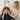 A frustrated woman looking at her reflection in a salon mirror, with a compassionate stylist standing behind her, ready to help.