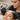 Close-up of a professional brow mapping technique using a ruler and thread to measure symmetry on a client's face before shaping