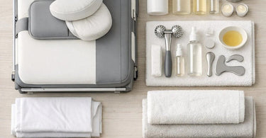 A well-organized portable massage kit featuring a folded table, linens, oils, and tools ready for on-the-go service.
