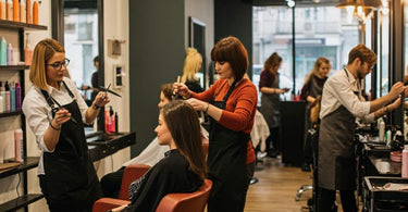 A bustling salon with stylists working and happy clients