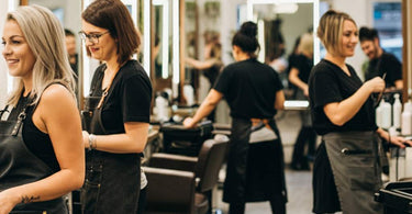 Busy modern hair salon with stylists and clients