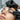 Close-up of a professional applying eyelash tint to a client with contact lenses