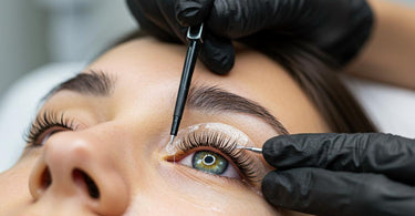 Close-up of a professional applying eyelash tint to a client with contact lenses