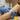 A peaceful client receiving a professional waxing treatment with numbing cream application