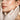 Close-up of a woman's face being gently treated with a creamy ceramide-rich serum by a professional esthetician in a spa setting