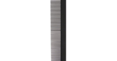 Champion Carbon Cutting Comb with Sectioning Tooth held by a professional stylist demonstrating precise hair sectioning on a salon client.