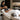 A professional spa therapist carefully positioning a supportive bolster under a client's knees during a long facial appointment to ensure optimal comfort and spinal alignment.