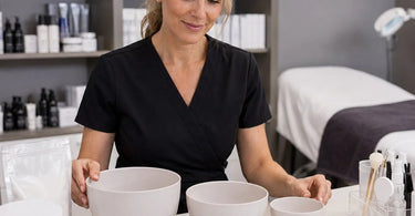 A selection of professional silicone mixing bowls in various sizes for alginate masks on a spa counter.