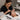 A detailed close-up of a professional lash artist carefully applying a gentle, hypoallergenic lash tape to a client's sensitive under-eye area before an eyelash extension service, showcasing products from Pure Spa Direct.