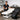 Professional massage table setup in a serene spa treatment room with bolsters and linens