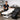 Professional massage table setup in a serene spa treatment room with bolsters and linens