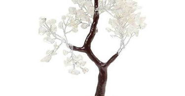 A beautiful clear quartz gemstone tree with polished stones as leaves on a twisted wire trunk, set on a white geode base, perfect for spa decor and retail.