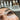 Close-up of beautifully applied lash extensions with a brush for aftercare