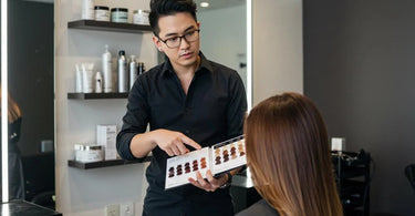 Hair stylist consulting with a client in a salon