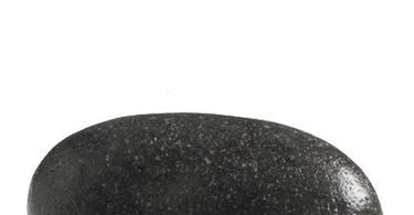 Contour Stone by Amber Products on a dark surface, featuring the signature ergonomic curve for professional massage and facial contouring