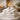 A luxurious spa setting showcasing neatly folded, high-quality white towels and plush robes arranged on a sleek shelf, evoking a sense of calm and professional elegance.