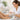 A spa professional performing a luxury pedicure, applying cream to a client's foot, with professional callus softening products and tools visible.