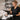 Relaxing shared salon suite interior with warm lighting, massage table, and professional spa products displayed on a wooden shelf.
