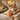 A serene spa treatment room setup for a sensory deprivation facial, showing a client with a blackout eye mask, comfortable bedding, and an esthetician's hands performing a gentle, focused facial massage in soft, dim light.