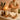 A spa professional warmly handing a client a product and a to-go tea as a signature send-off gesture