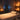 Spa professional adjusting music playlist during massage treatment with client