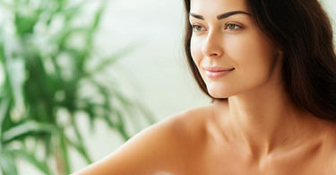 Relaxed woman enjoying a spa treatment with a towel wrapped around her head.