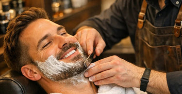 Professional barber performing a hot towel shave on a male client in a luxury grooming setting