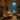 A serene and softly lit spa treatment room designed for introverted clients, featuring a comfortable massage table, warm towels, and calming ambiance