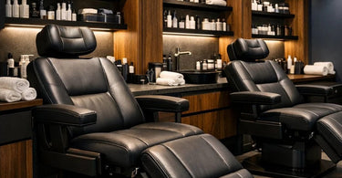 A modern, stylish spa treatment room designed for men's facials, featuring a sturdy, adjustable leather facial chair and warm, neutral decor.